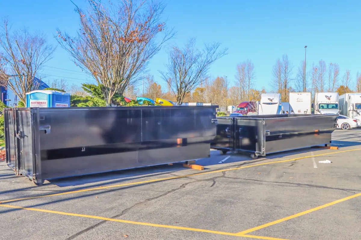 Professional dumpster rental service with roll-off container on residential driveway in Celebration
